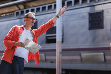Mature man traveler holding map asking for direction