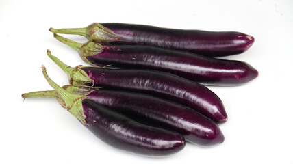 fresh raw healthy eggplants or aubergine vegetable on wooden plate. Food ingredient, vegetatian cuisine, organic greenhouse farm plant