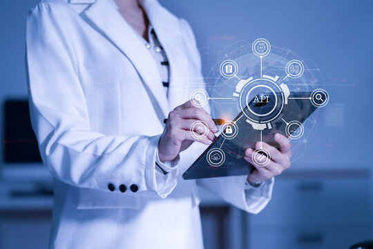 Modern technology and networking concept, woman using tablet with virtual screen API icon Software development tool. API Application Programming Interface.
