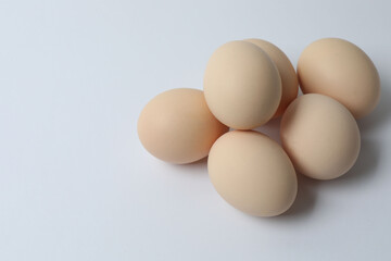 Chicken eggs in a basket, isolated on a white background

