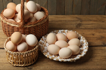 Chicken eggs in a basket placed on a wooden background