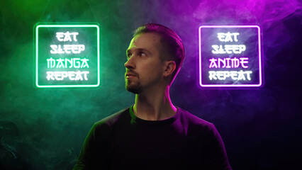 Male person look between two futuristic neon signs Eat Sleep Manga Repeat and Eat Sleep Anime Repeat