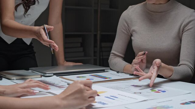 Business team collaborating on data analysis during night meeting