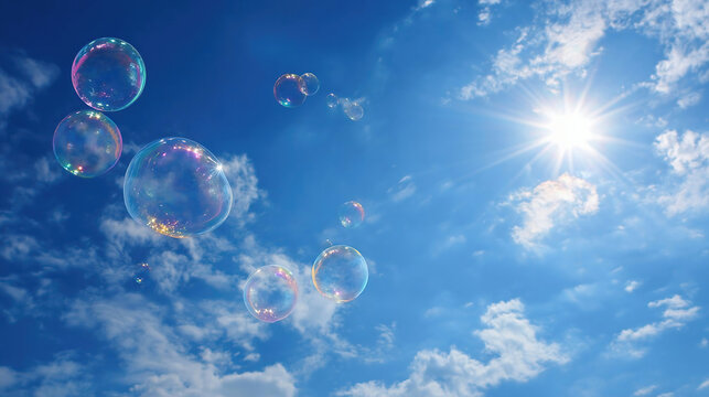 Soap bubbles fly in the air in the blue sky in the rays of the sun