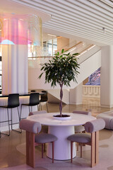 Modern interior design featuring a round table and greenery