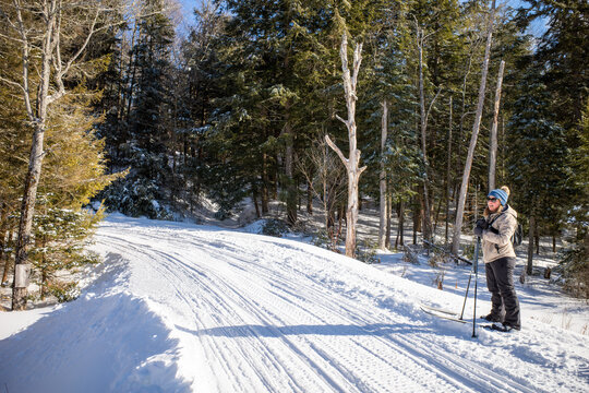 Female cross country skier enjoying snowmobile trails in NH