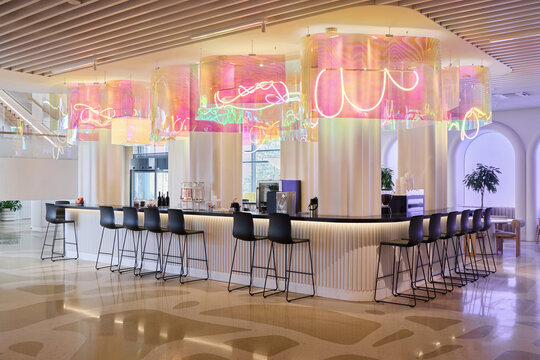 Bright and modern bar with colorful neon lights in a trendy location