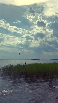 Kitesurfer in Action on the Water with Kite in the Sky