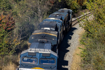 Train locomotives on curved track from above in natural environment