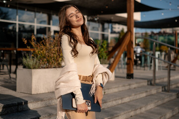 Young Woman Enjoying Sunlight with Laptop Outdoors