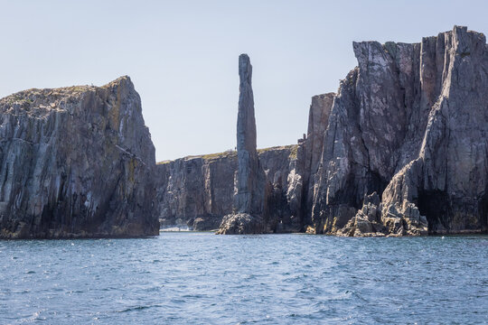 Towering Sea Stack Between Rugged Cliffs