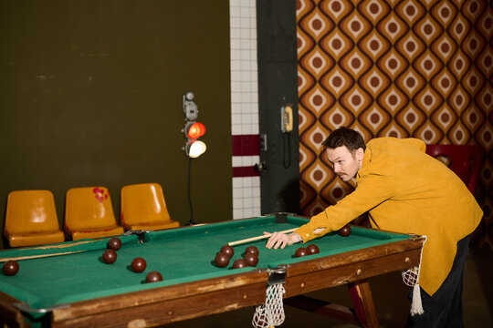 Man playing billiards in a retro-style lounge with brown balls