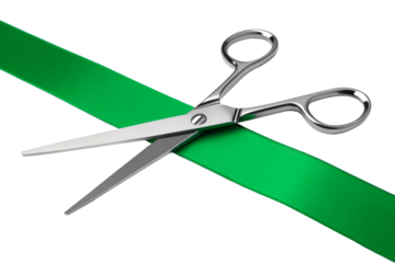 Silver Scissors Cutting Green Ribbon Across White Background