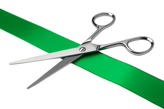 Silver Scissors Cutting Green Ribbon Across White Background