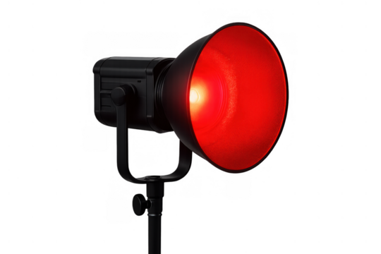 Studio light equipment with a red reflector, emitting a strong warm light, commonly used for photography or videography - Powered by Adobe
