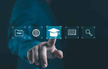 Businessman finger touching digital graduation cap icon among folder, globe, book, and search symbols, representing online education, e-learning, knowledge, and digital learning technology.