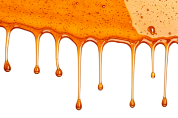 Viscous golden liquid dripping and forming bubbles