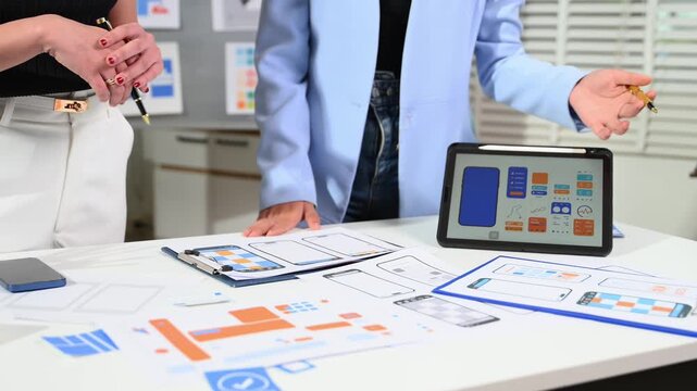 UX graphic designer planning application process development prototype wireframe for web smart phone. Creative digital development agency.