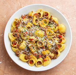 Pasta with bolognese sauce and cheese. Italian cuisine. Traditional recipe.