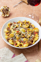 Pasta with bolognese sauce and cheese. Italian cuisine. Traditional recipe.