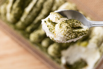 Matcha Tiramisu cake with green tea powder on top, Italian dessert fusion with Japanese