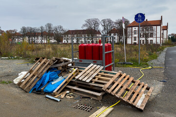 Construction debris and industrial propane gas cylinders near a bike path
