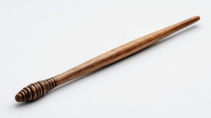Carved wooden wand tapered toward its tip with a ribbed base, set against a blank white background