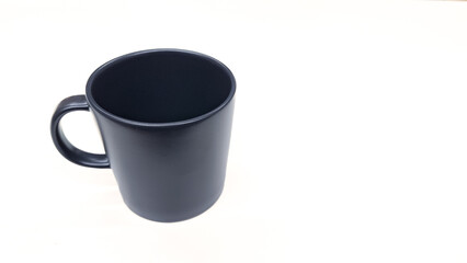 Empty ceramic gray mug on white background. dark grey tea cup isolated on white. Copy space