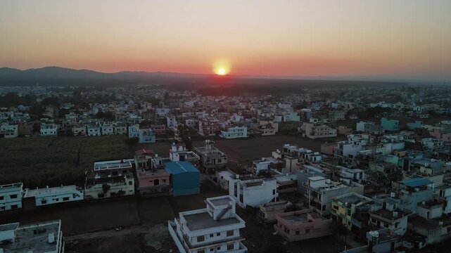 Aerial shot of an Indian city during sunset. Bird eye view of Dehradun, Uttarakhand, India. Beautiful urban India. Golden hour

