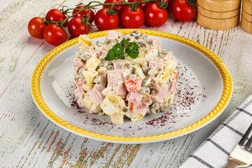 Russian traditional Olivier salad with sausages