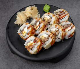 Eel uramaki with teriyaki glaze. Sweet glaze coats eel and rice while sesame adds crunch for a rich, menu ready roll.