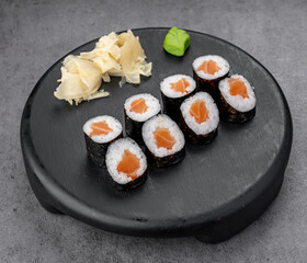 Classic salmon maki with nori and rice. Neat salmon cores sit in tight nori cylinders with rice, ready for stock or menu use.