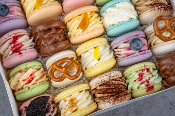 Colorful macarons assorted view. A bright selection of colorful macarons displayed close inside an open dessert box