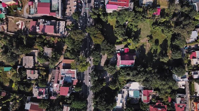 An aerial view of Dehradun, an Indian city during sunrise or sunset, with cloudy weather and rows of residential houses.