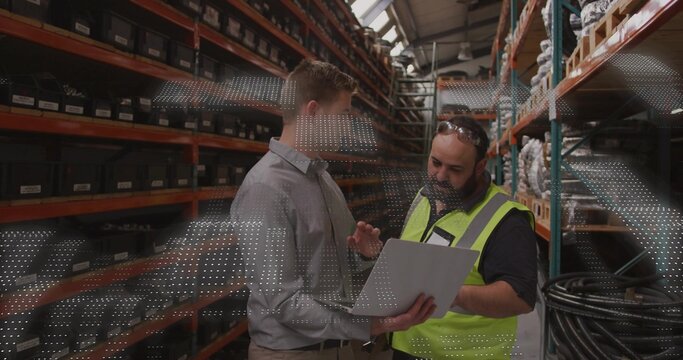 Holding tablet, two men wearing dress shirt and safety vest inspecting labeled bins in warehouse - Powered by Adobe