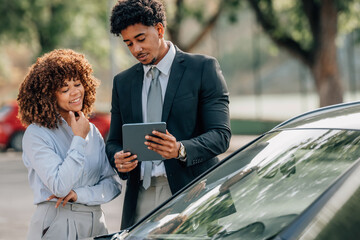 woman buying a car with a sales agent