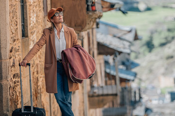 adult woman traveling with luggage and suitcase on the street