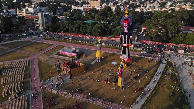 Aerial shot of the Ravan statue during the Dussehra or Vijayadashami Festival in Pared Ground, Dehradun, with traffic passing by alongside.