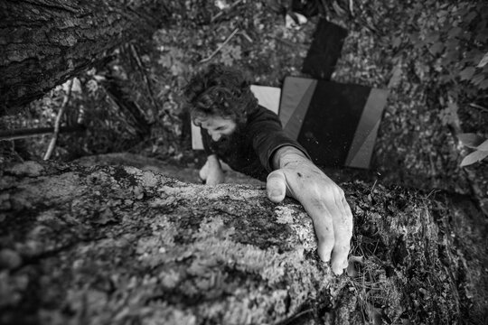 A top down view of a rock climber securing his grip on the edge