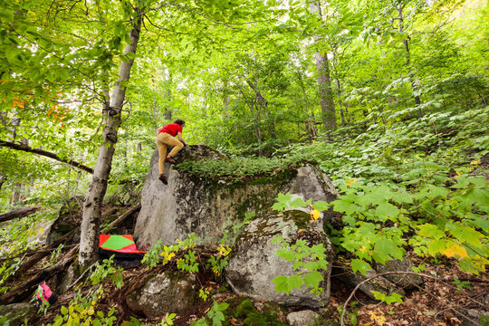A climber reaches the top of a short boulder problem