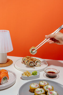 sushi set with chopsticks in hand