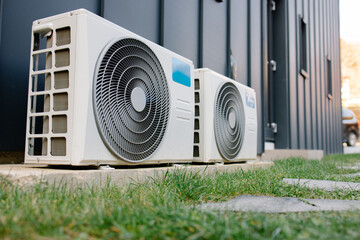 Two outdoor air conditioner units cooling modern building