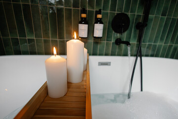 Relaxing bubble bath with lit candles and luxurious amenities
