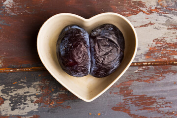 plum on a light background in the shape of a heart