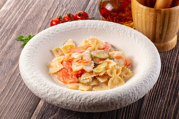 Italian pasta farfalle with salmon
