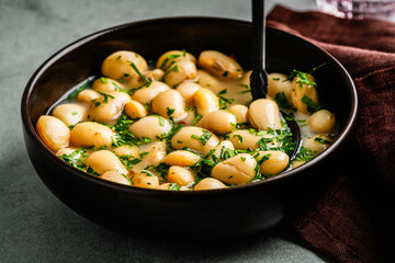 White beans stew with herbs, easy healthy dinner food, close up