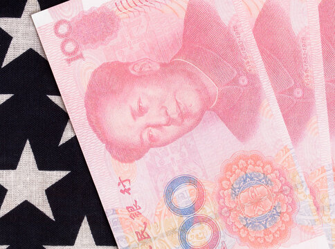 Chinese money and USA star flag