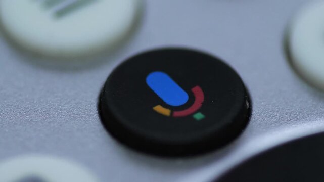 Close-up of Finger Pressing Voice Control Button on TV Remote, Activating Smart TV Voice Mode, Modern Home Technology Macro View