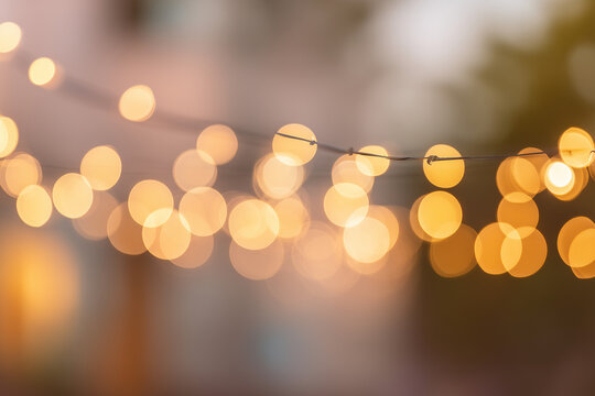 Warm glowing bokeh string lights creating a cozy festive atmosphere for outdoor parties, weddings, and home decor with soft golden tones