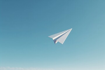 Fototapeta premium White paper airplane flying against clear blue sky